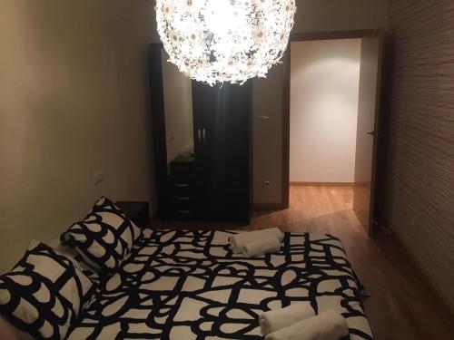 a living room with a bed and a chandelier at Tudela balcón de Bardenas in Tudela