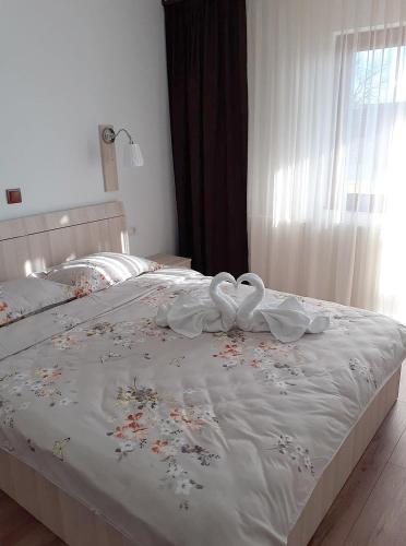 a bed with two white swans laying on it at Angela in Polovragi