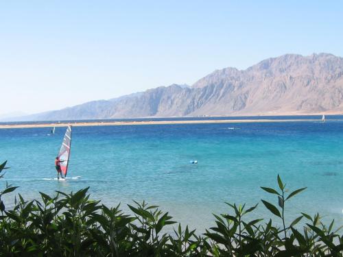 a person on a sail boat in the water at Deluxe Seahorse Apartment - Lagoon Villa in Dahab