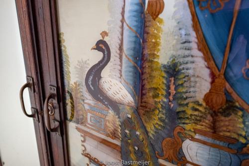 a painting of a peacock on a wall at Zanzibar Palace Hotel in Zanzibar City
