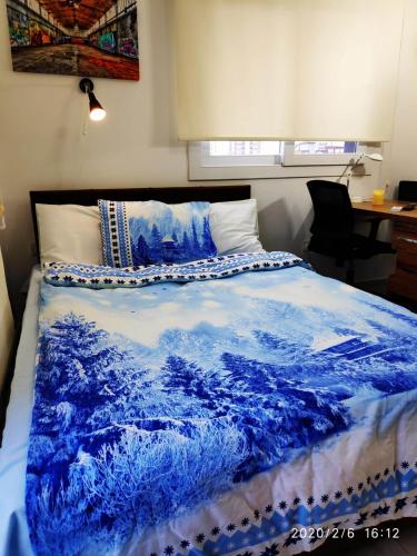 a bedroom with a blue blanket on a bed at RiX Studio Park Famagusta Contactless Check In & Check Out in Mağusa