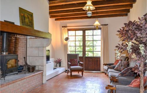 a living room with a fireplace and a couch and chairs at Beautiful Home In Durfort Lacapelette in Durfort