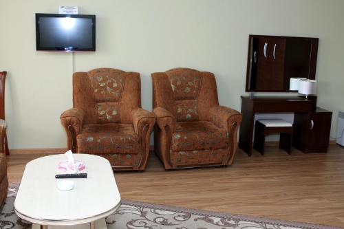 two chairs and a table in a living room at Golden Apricot in Gyumri