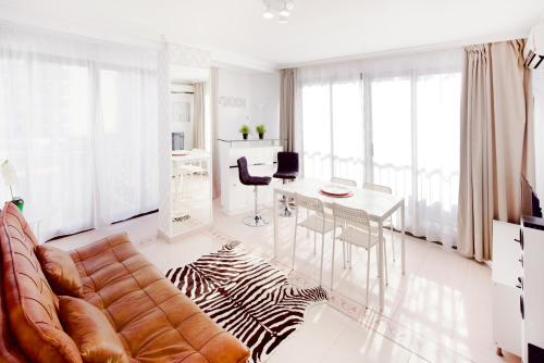 a living room with a couch and a table at My Pretty Payma Apartamentos in Benidorm