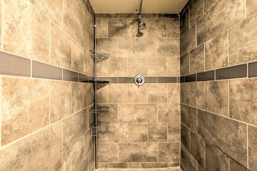 a bathroom with a shower with tiled walls at Butler Cabin on 19 Acres with Hot Tub and Fire Pit! in Butler