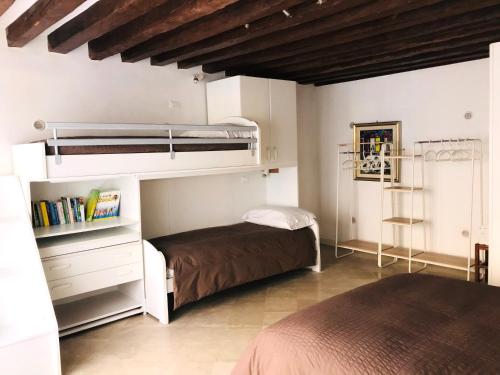 a bedroom with a bunk bed and a book shelf at La Coccola in Venice