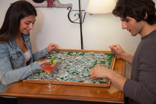 a man and woman looking at a puzzle on a table at Rabbit Hill Inn in Lower Waterford