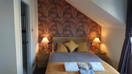 a bedroom with a bed with two towels on it at Ash Lea Hotel in Blackpool