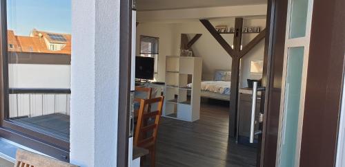 a room with a bed and a room with a balcony at Gemütliche Idylle am Seddinsee in Gosen