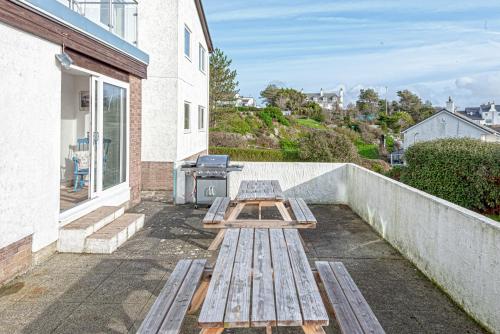 a picnic table on the balcony of a house at Carnedd - Trearddur Bay - Stanley-Stays in Trearddur