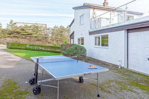 a ping pong table in front of a house at Carnedd - Trearddur Bay - Stanley-Stays in Trearddur