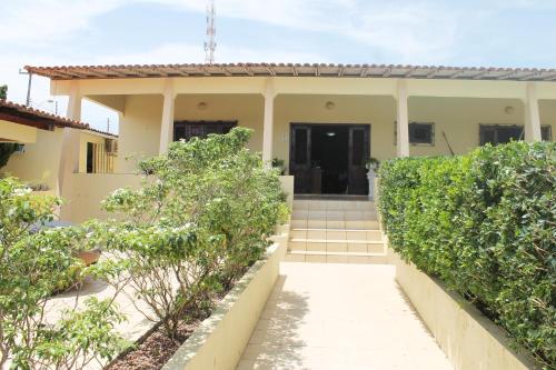 a house with a staircase in front of it at Hotel Pousada Calhau in São Luís
