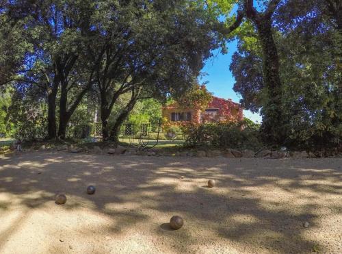 a group of balls on the ground in front of a house at Domaine du Bois d'Amont in Cabris