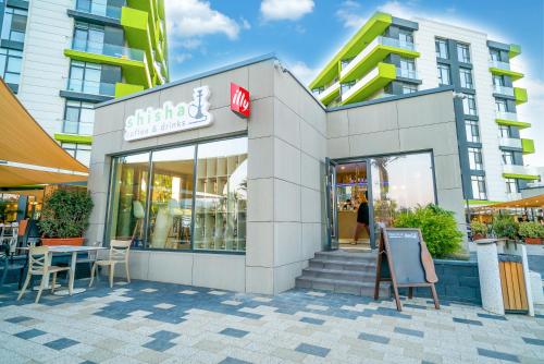 a store with a sign in front of a building at Alezzi Beach Resort in Mamaia Nord