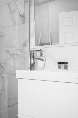 a bathroom with a sink and a mirror at West Rock Villas in Saint James