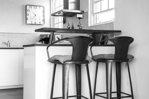 two bar stools at a counter in a kitchen at West Rock Villas in Saint James