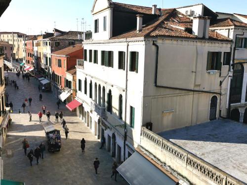 a group of people walking down a street with buildings at Cannaregio apartment in Venice