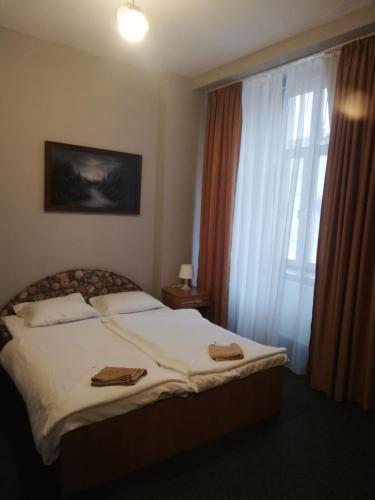 a bedroom with a bed with two towels on it at Albatros in Świnoujście