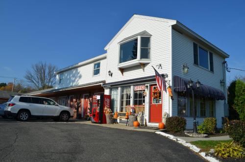 a white building with a car parked in front of it at Williamstown Motel in Williamstown