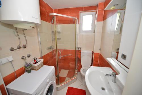 a bathroom with a shower and a toilet and a sink at Apartment Mirela in Sarajevo