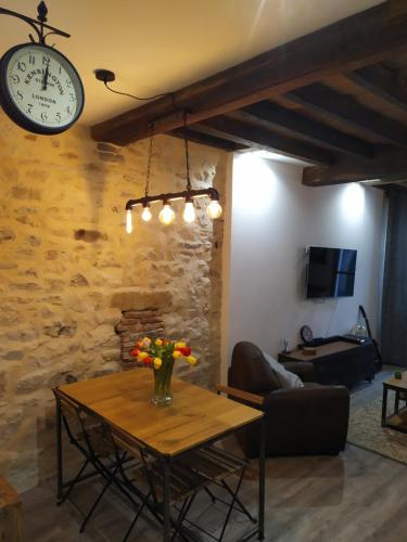 - un salon avec une table et une horloge murale dans l'établissement Carré des Halles Centre Historique, à Bayonne