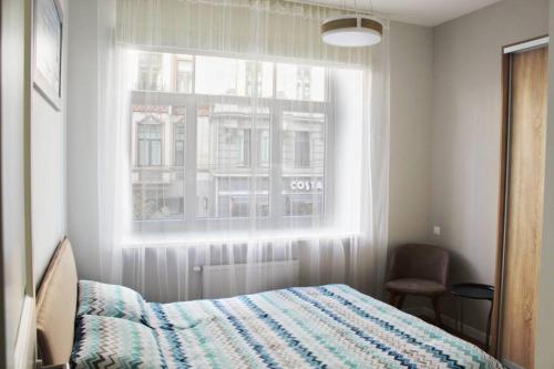 a bedroom with a bed and a window at Riga Central Park Apartment in Riga