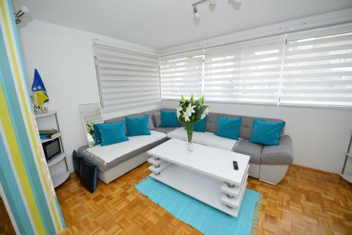 a living room with a couch and a table at Apartment Mirela in Sarajevo