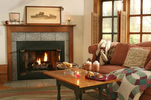 a living room with a couch and a fireplace at Rabbit Hill Inn in Lower Waterford