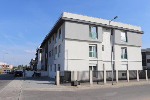 a white building on the side of a street at Foxxy Luxury Apartments in Skopje