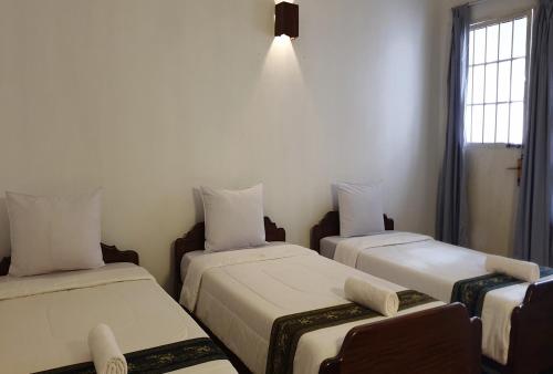 Ein Bett oder Betten in einem Zimmer der Unterkunft Smiley's Guesthouse