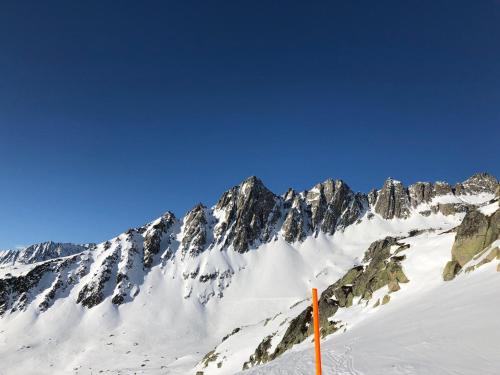a snow covered mountain with a blue sky at Casa Schuoler in Disentis