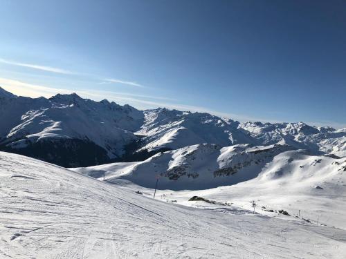 a snow covered mountain with mountains in the background at Casa Schuoler in Disentis