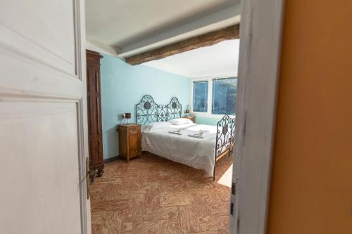 a bedroom with a bed and a window at Albergo Diffuso Ca' Spiga in Laglio