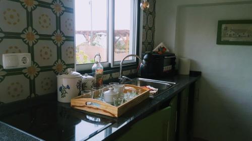 a kitchen counter top with a sink and a counter top at Quinta do Lago in São Roque do Pico