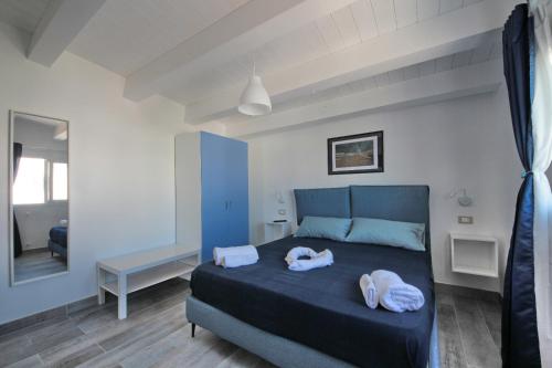 a bedroom with a bed with two towels on it at Amareilmare2 in Marzamemi