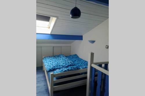 une chambre avec un lit dans une pièce avec une fenêtre dans l'établissement Le Tribord - ambiance bateau avec balcon à 30 m de la plage, à Palavas-les-Flots