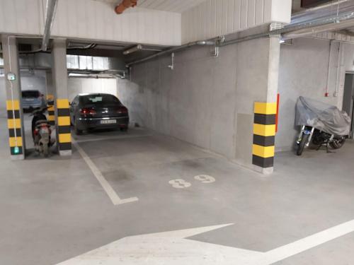 a parking garage with a car parked in it at Schindler’s Factory Zabłocie Deluxe Apartments WAWELOFTS in Kraków