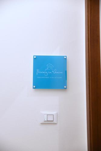 a sign on a white wall with a car on it at Privacy in Venice - Your apartment to be let alone in Venice