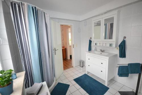 a bathroom with a white sink and a mirror at Haus Tina in Mölln