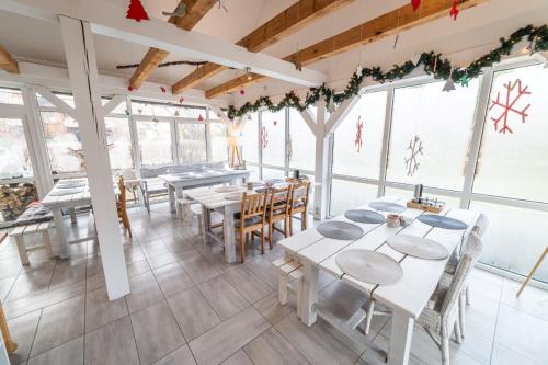 a restaurant with tables and chairs and christmas decorations at Gosciniec Szuwary in Krutyń