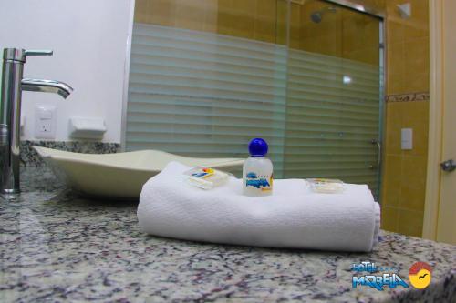 a bathroom with a roll of toilet paper and a bath tub at Hotel Marbella in Manzanillo
