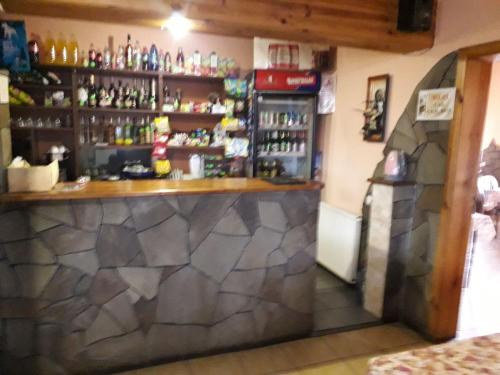 a bar in a restaurant with a stone wall at Отель Виктория in Berezyna