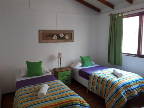 מיטה או מיטות בחדר ב-Cabañas Del Potrero