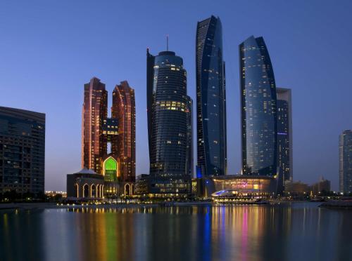 a view of a city skyline at night at Bab Al Qasr Residence in Abu Dhabi