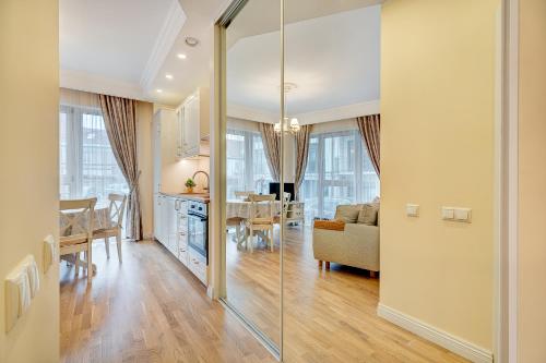 a kitchen and living room with a dining room at HaPPy Inn Classical style, self check-in, Parking in the underground garage in Vilnius