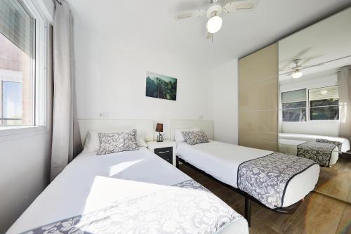 Postel nebo postele na pokoji v ubytování Sonrisa Apartments