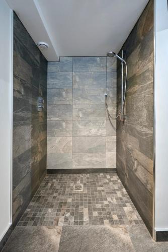 a bathroom with a shower with a glass door at Dalecote Barn Bed & Breakfast in Ingleton