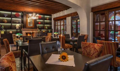 a restaurant with tables and chairs and a fireplace at Hotel Boutique Casa Colorada in Pátzcuaro