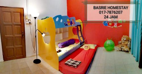 a childs bedroom with a bunk bed and a slide at Basrie Villa Pagoh - Mini Cinema , Karaoke , Private Pool , WiFi , NetFlix in Muar