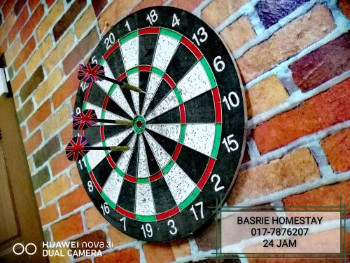 a dart board attached to a brick wall at Basrie Villa Pagoh - Mini Cinema , Karaoke , Private Pool , WiFi , NetFlix in Muar
